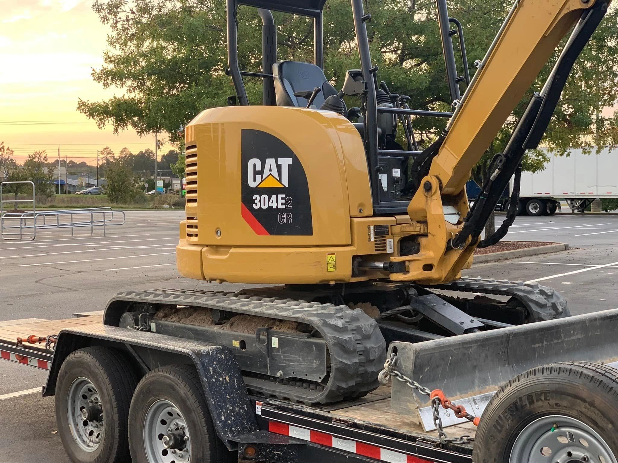 CAT 304E2 CR compact excavator on trailer